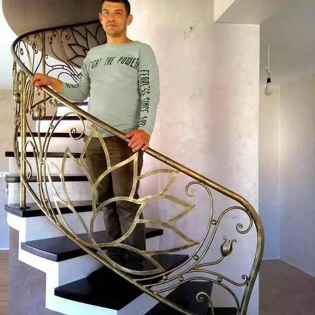 Goldish curly interior wrought iron stair railing. 165